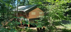 a tree house in the middle of a forest at Chalets de vacances Castelwood in Biron