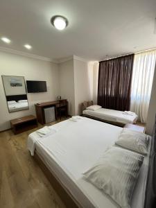 Postel nebo postele na pokoji v ubytování Ventura Hotel
