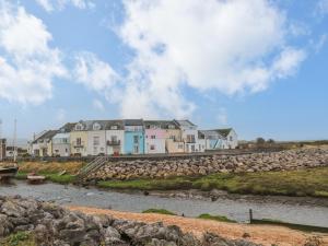 a row of houses on the shore of a river at The Lookout in Millom