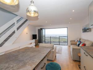a kitchen and living room with a view of the ocean at The Lookout in Millom
