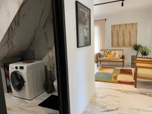 a living room with a washer and dryer at Cozy beach house Jurmala II in Jūrmala