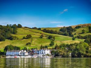 a house on a hill next to a body of water at Rayside in Penrith