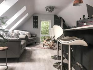 a living room with a couch and a chair at Treetops in Newton Poppleford