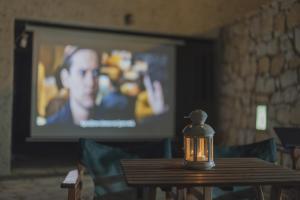 a candle sitting on a table in front of a television at Akti Apollona in Apollon