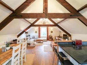 a kitchen and living room with wooden beams at Old Chapel in Exeter