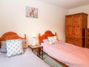 a bedroom with two beds and a dresser at Old Chapel in Exeter