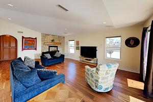 a living room with two blue couches and a television at Pierpont Coastal Dreams in Ventura