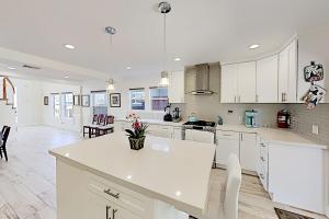 a kitchen with white cabinets and a white counter top at Pierpont Coastal Dreams in Ventura