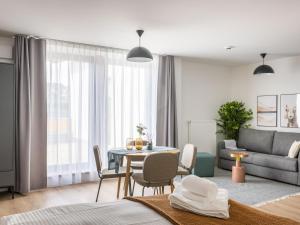 a living room with a table and a couch at Limehome Bodenmais Bahnhofstraße in Bodenmais