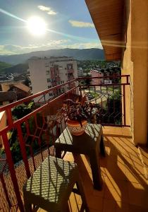 a balcony with a table and chairs on a building at RAJSKA PTICA in Višegrad +2 photos