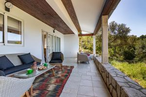 eine Terrasse mit einem Sofa und einem Tisch in der Unterkunft Villa Pinus in Stari Grad