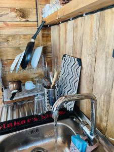 a kitchen sink with a kitchen utensils at Караваната на Стела in Sozopol