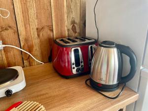 a counter with a toaster and a coffee maker on it at Караваната На Морето in Sozopol