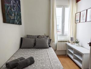 a small bedroom with a bed and a window at Living Plaza de la Paja in Madrid