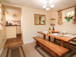 a kitchen and dining room with a wooden table at Hedgehog Cottage in Minehead