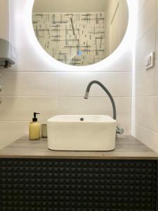 a bathroom with a white sink and a mirror at Apartmani CUBE L in Medulin