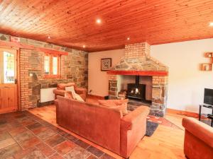 a living room with couches and a stone fireplace at 4 Killimer Road in Kilrush