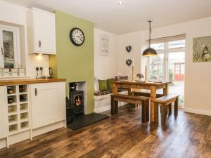 cocina y comedor con mesa y chimenea en Kirkby House, en Carnforth