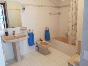 a bathroom with a sink and a toilet and a tub at La Trufa - modern, spacious home in Moraira with panoramic sea views in Moraira +22 photos