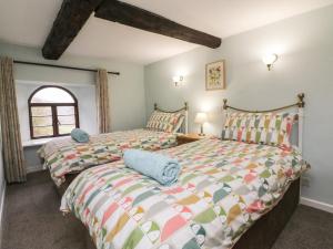 two beds sitting next to each other in a bedroom at Barn Owl Cottage in Minehead