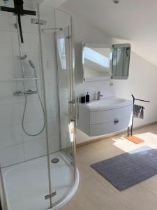 a bathroom with a glass shower and a sink at Ferienwohnung Burgzauber in Kastellaun