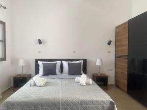 a bedroom with a large bed with two night stands at Aegean Endless Summer Villa Pefkos in Pefki