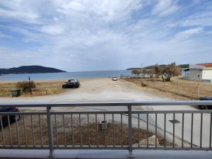 a view of a parking lot next to the water at Eva Beach Apartment in Nea Peramos