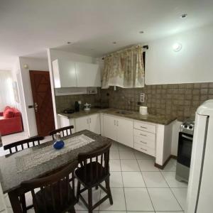 a kitchen with a table and chairs and a counter top at Villa Domenico in Salvador