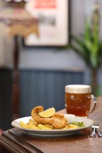 a plate with onion rings and french fries and a cup of tea at Pont y Pair Inn in Betws-y-coed