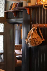 a purse hanging on a wall in a room at Pont y Pair Inn in Betws-y-coed
