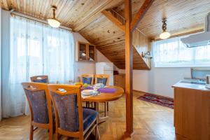 a kitchen and dining room with a table and chairs at Apartamenty pod Kotwicą in Ustka