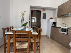 a kitchen with a table and chairs in a kitchen at LUNAR MELODY in Karpathos