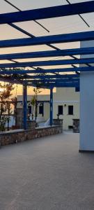 an empty parking lot with blue poles and a building at LUNAR MELODY in Karpathos