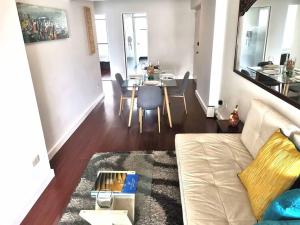 a living room with a white couch and a table at Espacio Luxury Apartments Malecón 2 in Lima