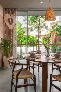 a dining room with a table and chairs and a balcony at Peaceful 1BR in Veleta, Pool & Balcony - A203 in Tulum