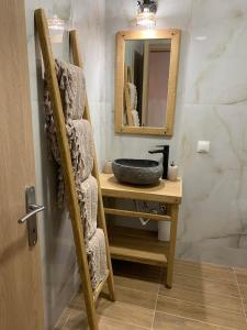 a bathroom with a sink and a mirror at DEL REY in Paralia Katerinis