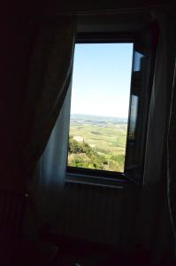 a window in a room with a view of a field at La Terrazza sull'Alba in Montalcino