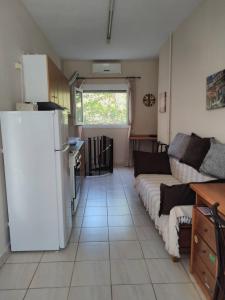 a living room with a refrigerator and a couch at Cosy Studio Down Town in Kavala