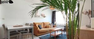 a living room with a couch and a table at Appartementje 57 Middelkerke in Middelkerke