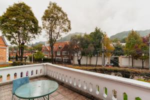 a table on a balcony with a view of a city at ApartaSuites & Hotel Bogota Plaza 36 in Bogotá