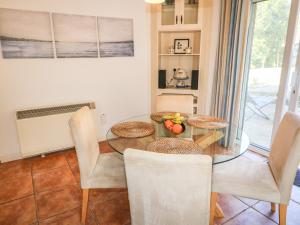 a dining room with a glass table and chairs at 1 Closheen Lane in Rosscarbery