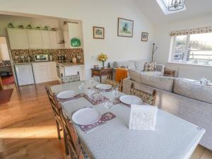 a dining room and living room with a table and chairs at Stubb Oak in Malvern Wells