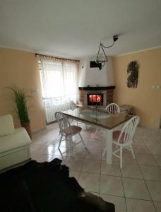 a living room with a table and chairs and a fireplace at Apartma Qbed in Gračišče