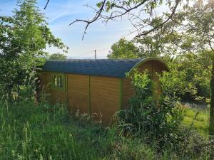 a small cabin in the middle of a field at LES ROULOTTES DU PILAT in Maclas