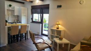 a small living room with a kitchen and a living room at Guest House Iva in Slunj
