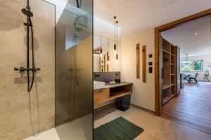 a bathroom with a shower and a sink at Glückhoch2 in Hochfilzen