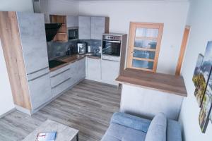 a kitchen with a blue couch in a room at Minihotel Vitex in Prague