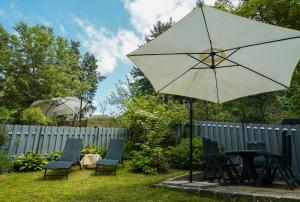 a table and chairs and an umbrella in a yard at Minihotel Vitex in Prague