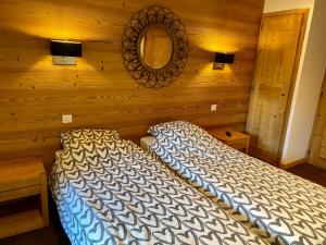 a bedroom with a bed in a wooden wall at Le REFUGE DES PORTES DU MONT BLANC in Vallorcine