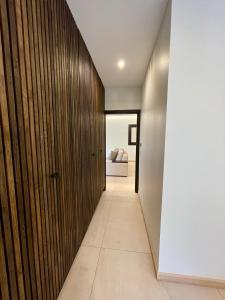 a hallway of a house with a wooden wall at Mogador in Bonifacio